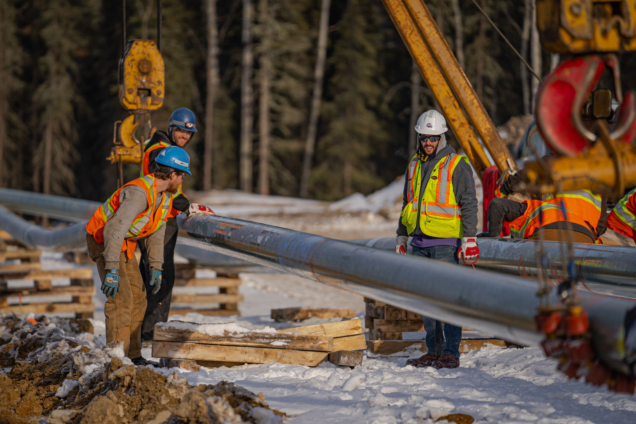 Construction workers installing pipeline