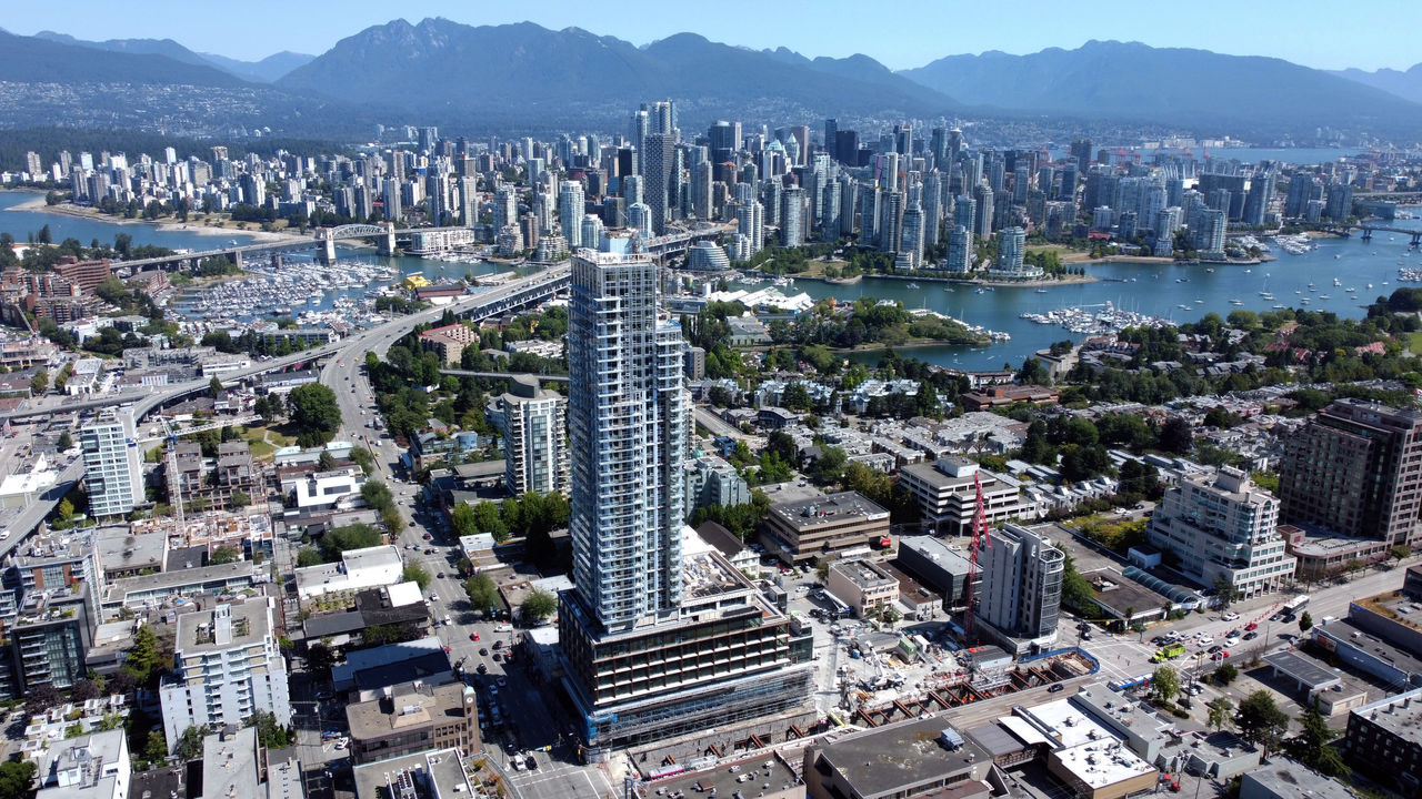 An aerial drone shot of a mixed use residential tower 