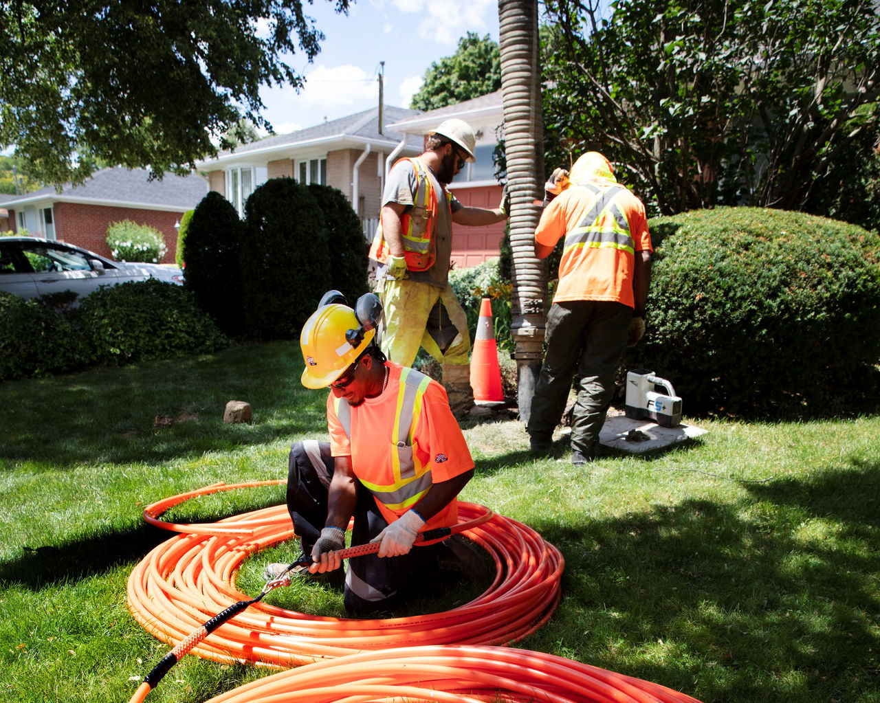 Ledcor worker installing wires.